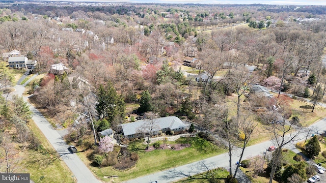drone / aerial view with a wooded view