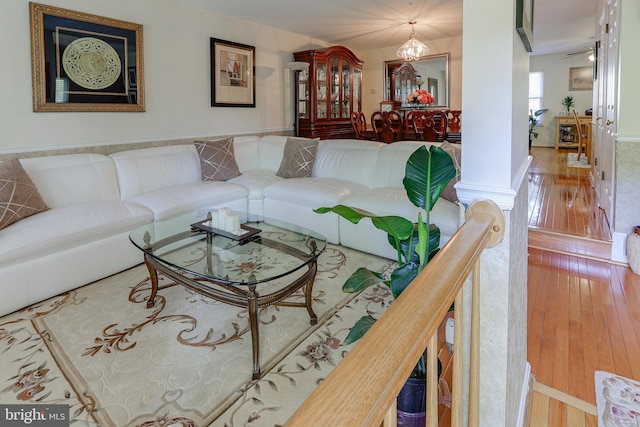 living area with a notable chandelier and hardwood / wood-style floors