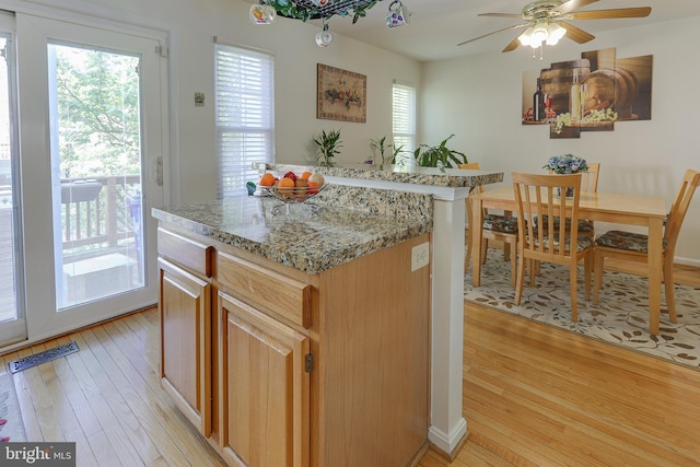 kitchen with visible vents, light wood-style flooring, and a center island
