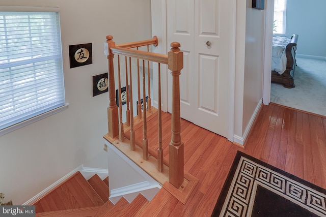 stairway featuring baseboards and wood finished floors