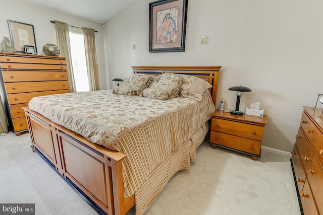 bedroom featuring light colored carpet and baseboards