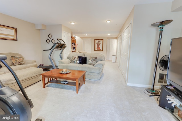 living room featuring recessed lighting, baseboards, and light carpet