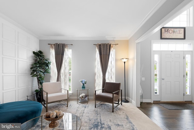 foyer entrance featuring baseboards, ornamental molding, and wood finished floors
