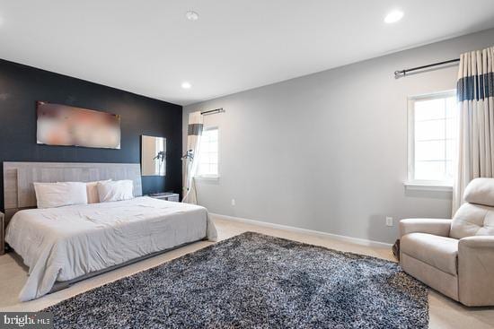 bedroom featuring carpet flooring, recessed lighting, baseboards, and an accent wall