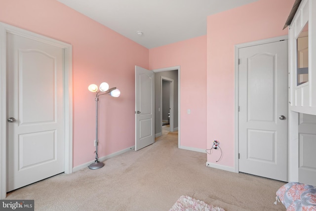 unfurnished bedroom with baseboards and carpet flooring