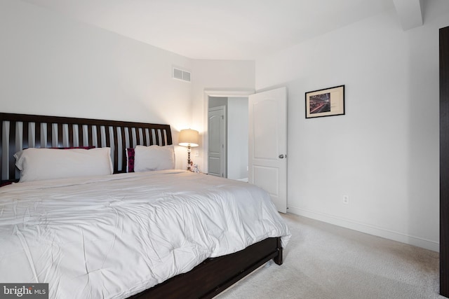 bedroom with carpet floors, baseboards, and visible vents