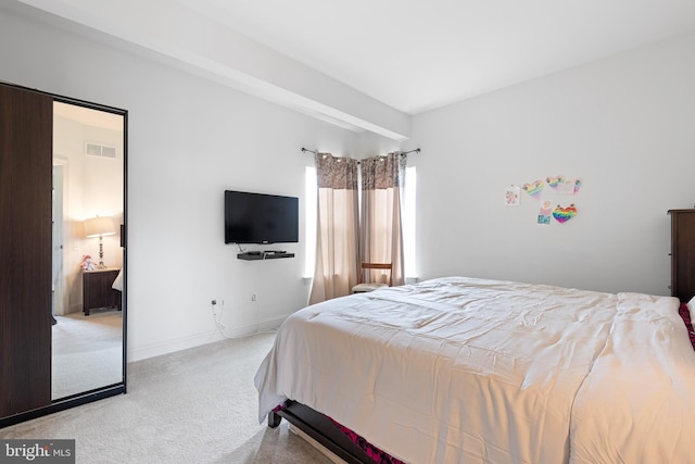 bedroom featuring baseboards, light colored carpet, and visible vents