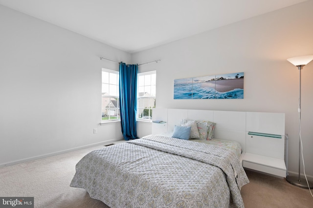 carpeted bedroom with baseboards and visible vents