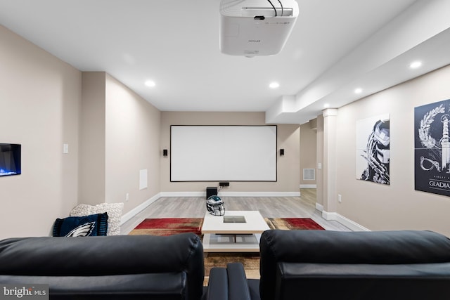cinema room featuring recessed lighting, baseboards, visible vents, and light wood-type flooring