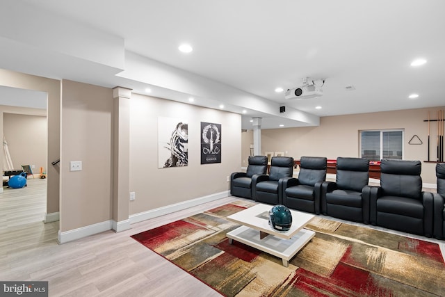 cinema featuring recessed lighting, baseboards, ornate columns, and light wood-style floors
