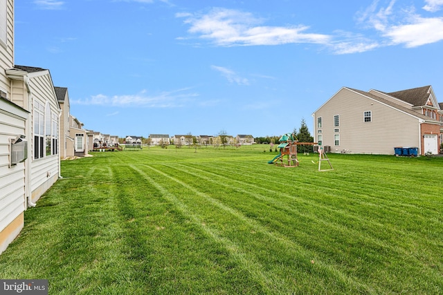 view of yard with a playground and a residential view