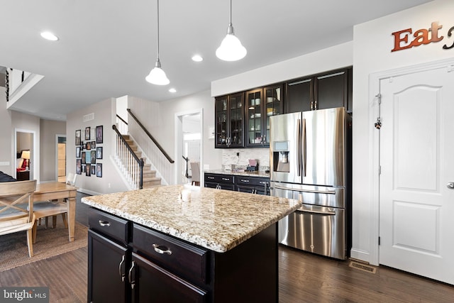 kitchen featuring visible vents, pendant lighting, dark wood-style flooring, and stainless steel fridge with ice dispenser