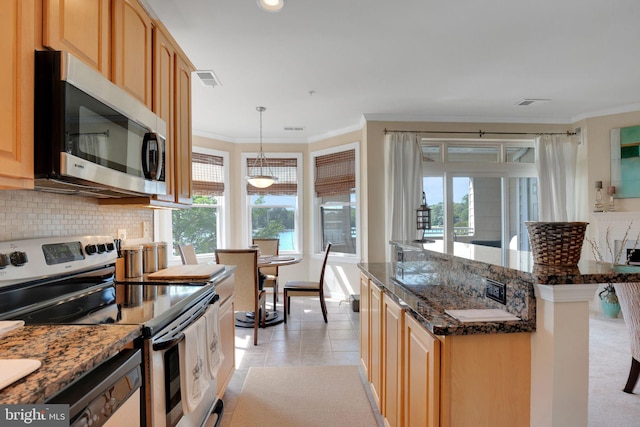 kitchen featuring appliances with stainless steel finishes, tasteful backsplash, light tile patterned floors, dark stone counters, and ornamental molding