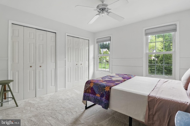 9116 John Way, Fairfax Station, VA 22039 - carpeted bedroom with two closets, multiple windows, and ceiling fan