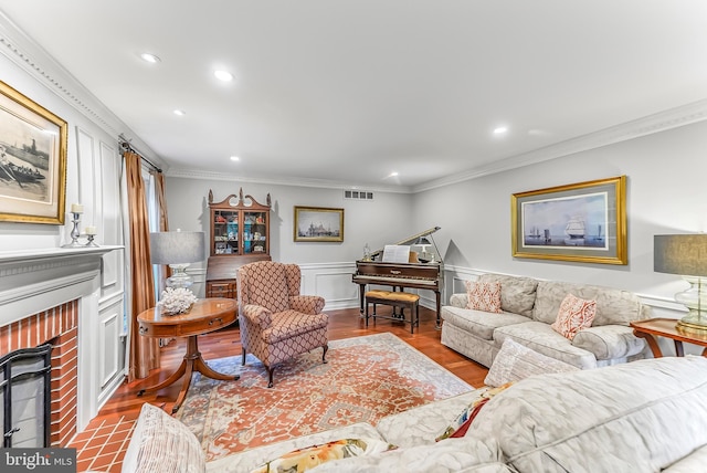 318 Longwood Rd, Kennett Square, PA 19348 - living area with a fireplace, ornamental molding, recessed lighting, wood finished floors, and a wainscoted wall