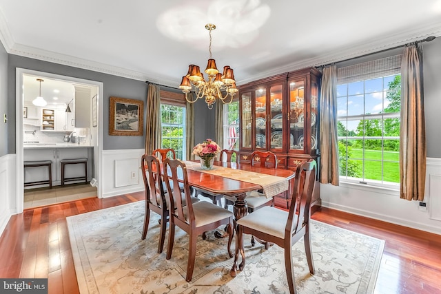 318 Longwood Rd, Kennett Square, PA 19348 - dining room with a chandelier, ornamental molding, wood-type flooring, and a wainscoted wall