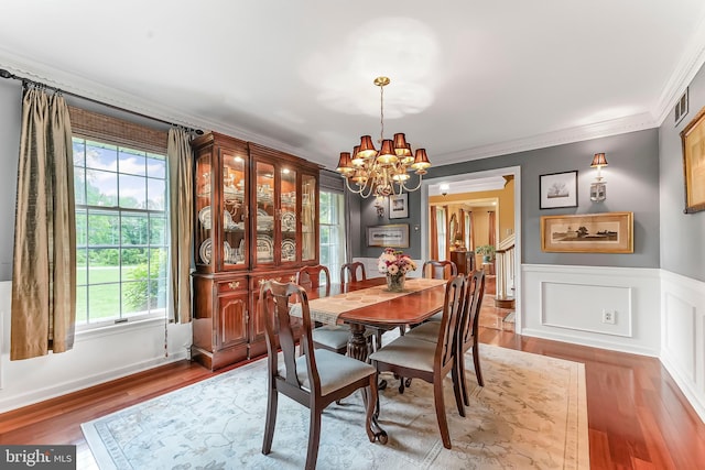 318 Longwood Rd, Kennett Square, PA 19348 - dining space with a chandelier, wood finished floors, ornamental molding, and wainscoting