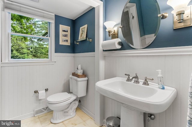 318 Longwood Rd, Kennett Square, PA 19348 - bathroom featuring wainscoting, a sink, toilet, and tile patterned floors