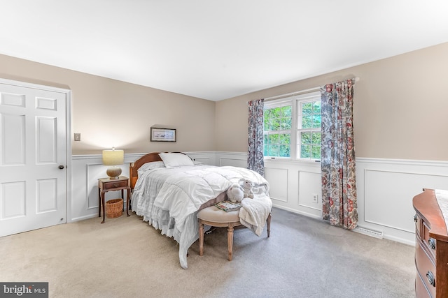 318 Longwood Rd, Kennett Square, PA 19348 - bedroom featuring wainscoting, a decorative wall, and light colored carpet
