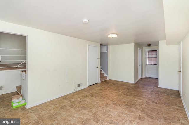 8809 Vernon View Dr, Alexandria, VA 22308 - empty room featuring stairway, stone finish flooring, baseboards, and a smoke detector