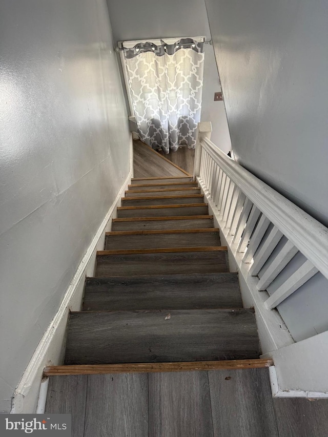 stairway featuring wood finished floors