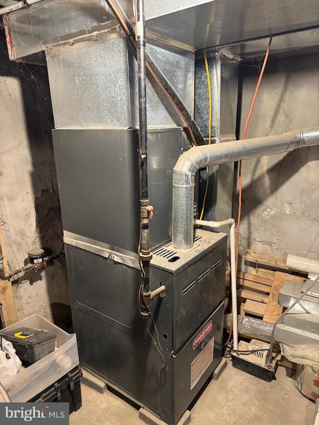 utility room featuring heating unit
