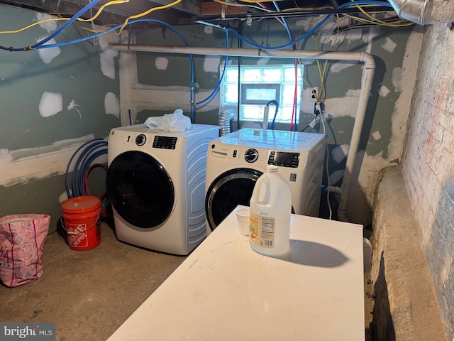 washroom featuring separate washer and dryer and laundry area
