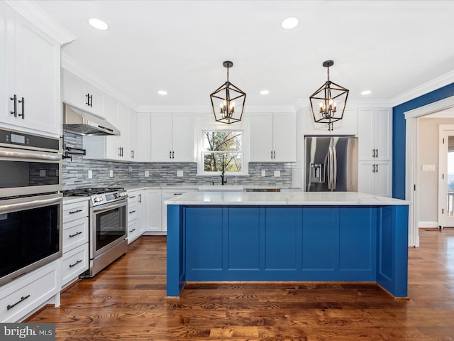 kitchen with white cabinetry, under cabinet range hood, a sink, appliances with stainless steel finishes, and a notable chandelier