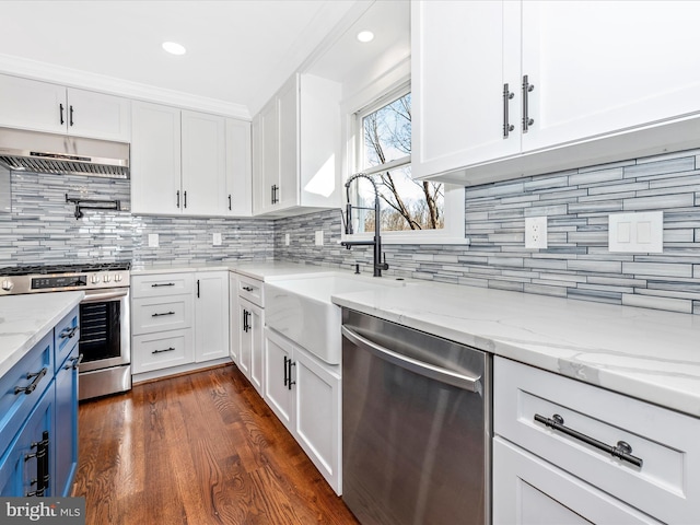 kitchen featuring a sink, white cabinetry, appliances with stainless steel finishes, and under cabinet range hood
