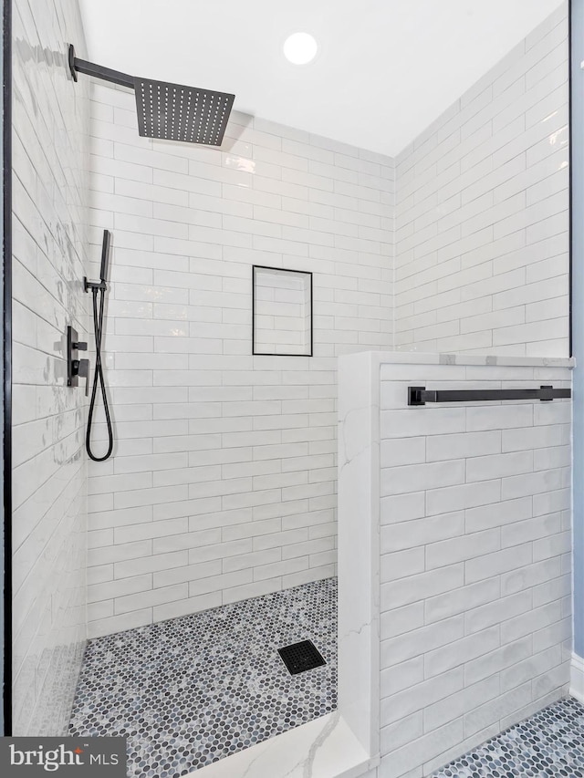 bathroom with recessed lighting and tiled shower