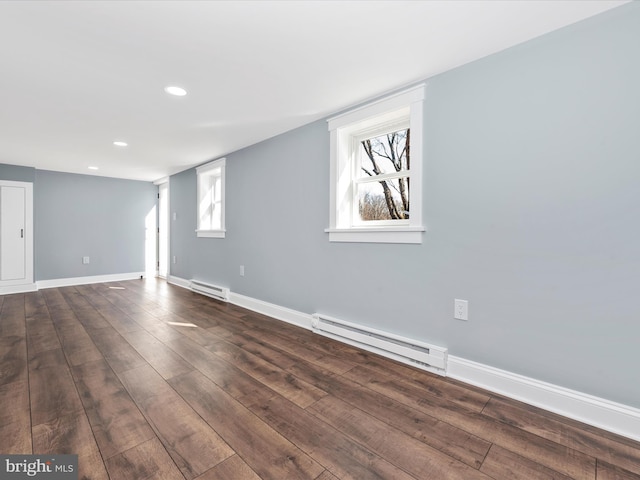 below grade area featuring baseboards, a baseboard radiator, and dark wood-style floors