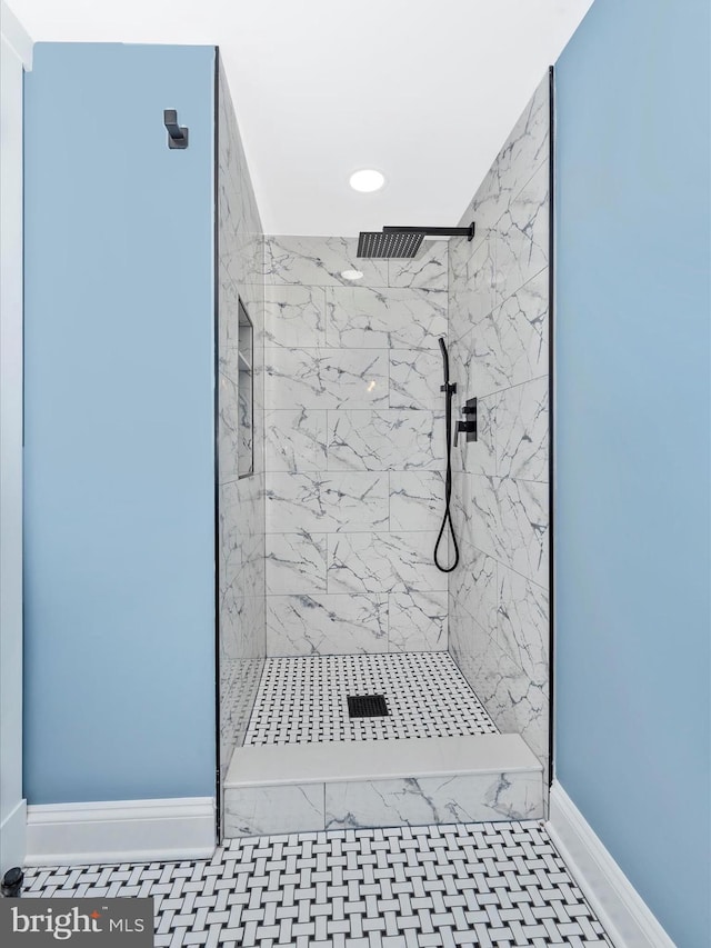 bathroom featuring a marble finish shower, baseboards, and recessed lighting