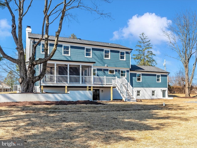 back of house with a deck, a chimney, stairs, central AC unit, and a sunroom
