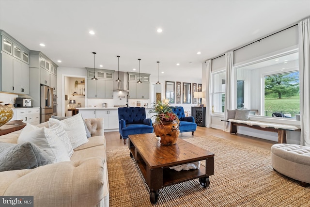 living area with light wood-style floors and recessed lighting