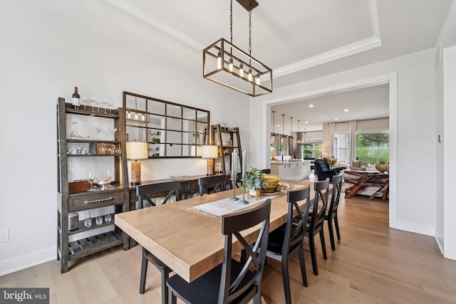 dining area with baseboards, wood finished floors, and an inviting chandelier