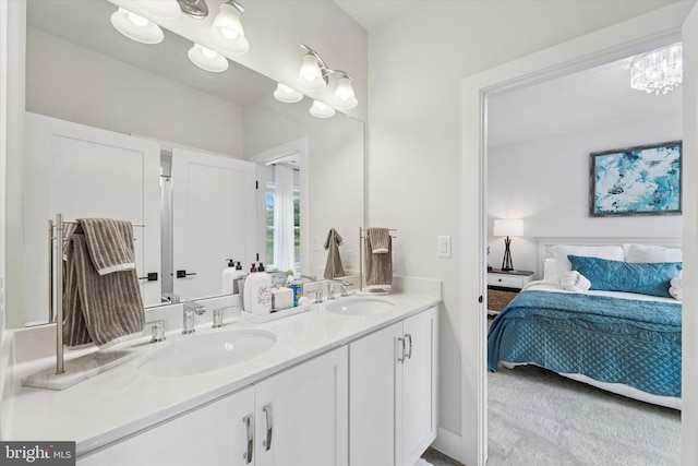 full bathroom with double vanity, a sink, and ensuite bathroom