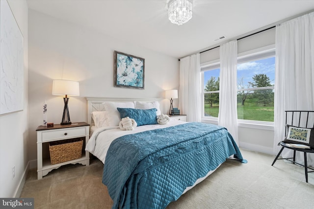 carpeted bedroom with baseboards and visible vents