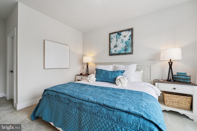 bedroom with baseboards and carpet