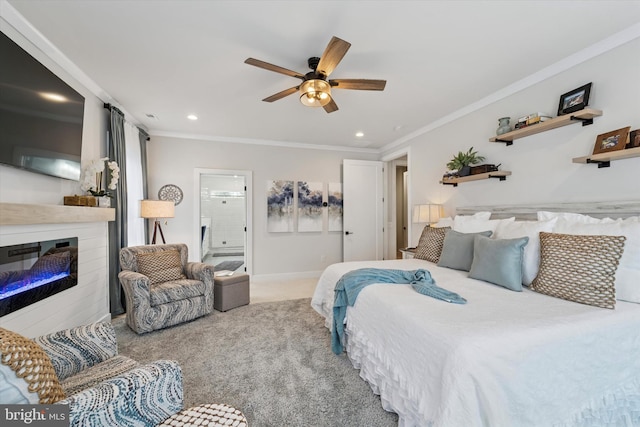 carpeted bedroom with a glass covered fireplace, ornamental molding, and recessed lighting
