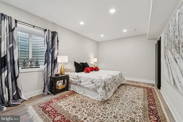 bedroom with baseboards, recessed lighting, and wood finished floors
