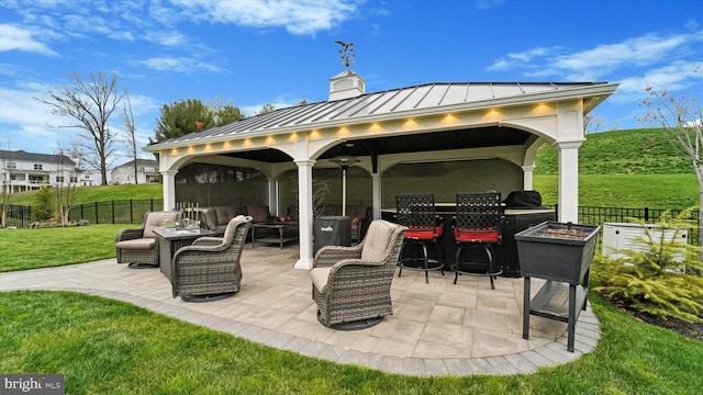 view of patio / terrace featuring a gazebo, fence, and an outdoor hangout area