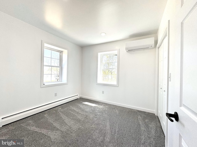 unfurnished bedroom with carpet flooring, baseboards, multiple windows, a wall mounted AC, and a baseboard radiator