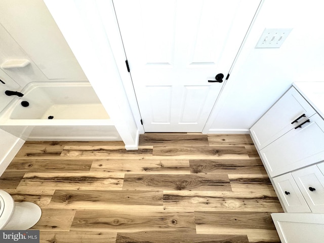 bathroom with walk in shower and wood finished floors