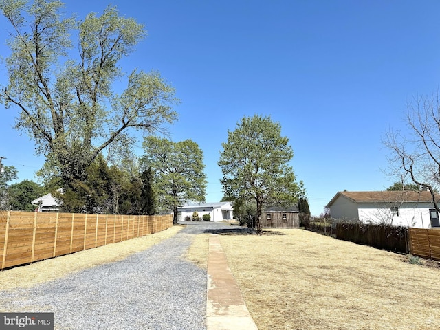 view of front of property featuring fence and driveway