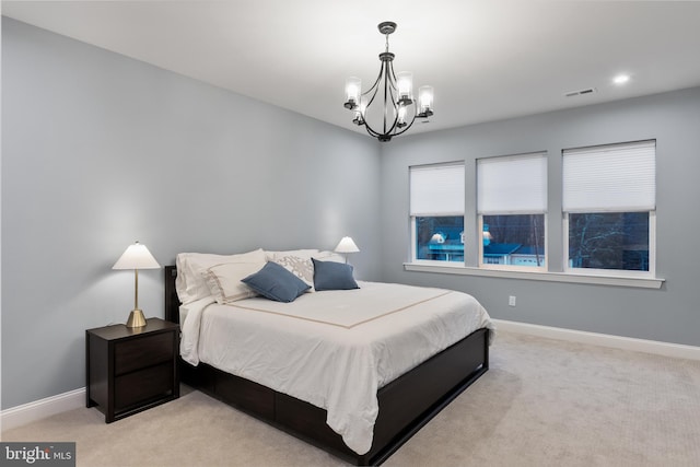 bedroom with baseboards, a notable chandelier, light colored carpet, and visible vents