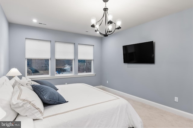 bedroom featuring baseboards, carpet flooring, a notable chandelier, and visible vents