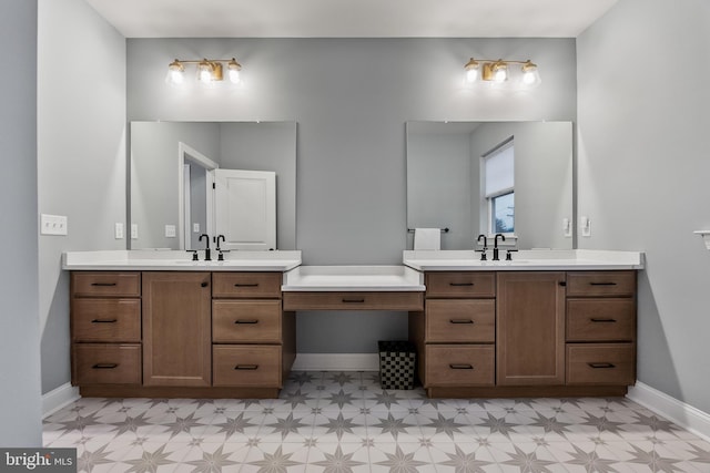 full bathroom with tile patterned floors, a sink, two vanities, and baseboards