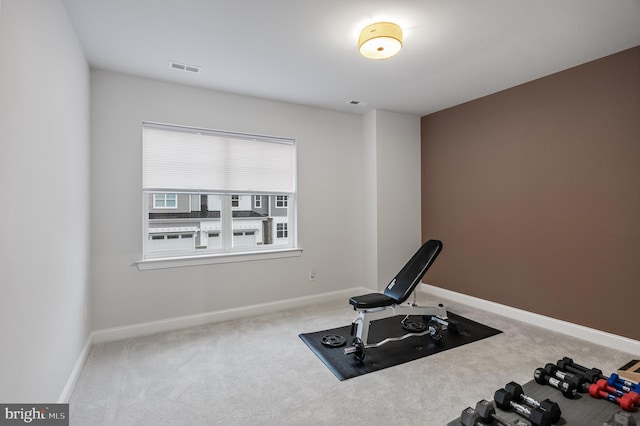 workout room with carpet flooring and baseboards