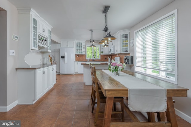 dining area featuring baseboards and tile patterned floors