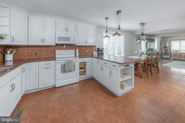 kitchen with open shelves, light tile patterned flooring, and white appliances